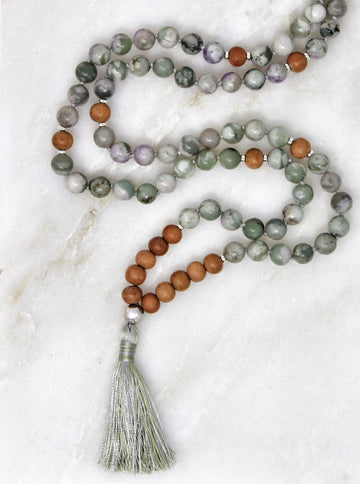 Serenity mala hand-strung with peace jade and sandalwood beads with sterling silver lotus and findings.