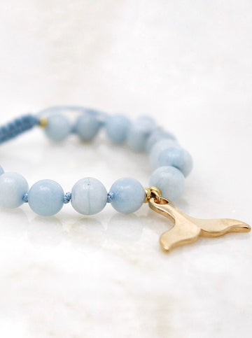 Yemaya bracelet  hand-knotted with 8mm Grace A Aquamarine beads and strung with a gold plated Whale/Mermaid tail pendant. 